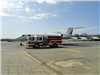 Fire Truck Parked Next to Jet