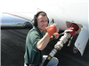 Man Putting Fuel in Airplane