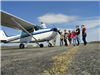 People Standing Next to Small Airplane