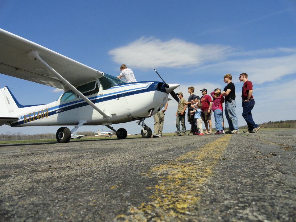 People Standing Next to Small Airplane